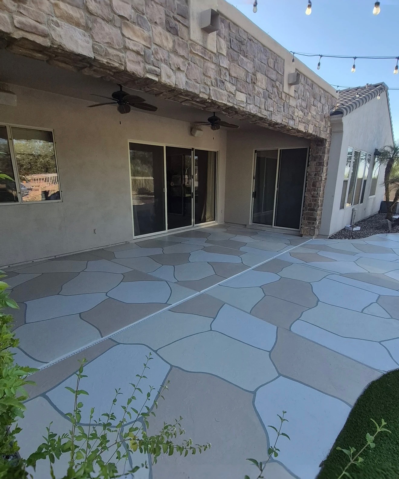 Gray flagstone-pattern concrete patio resurfacing behind a Phoenix home