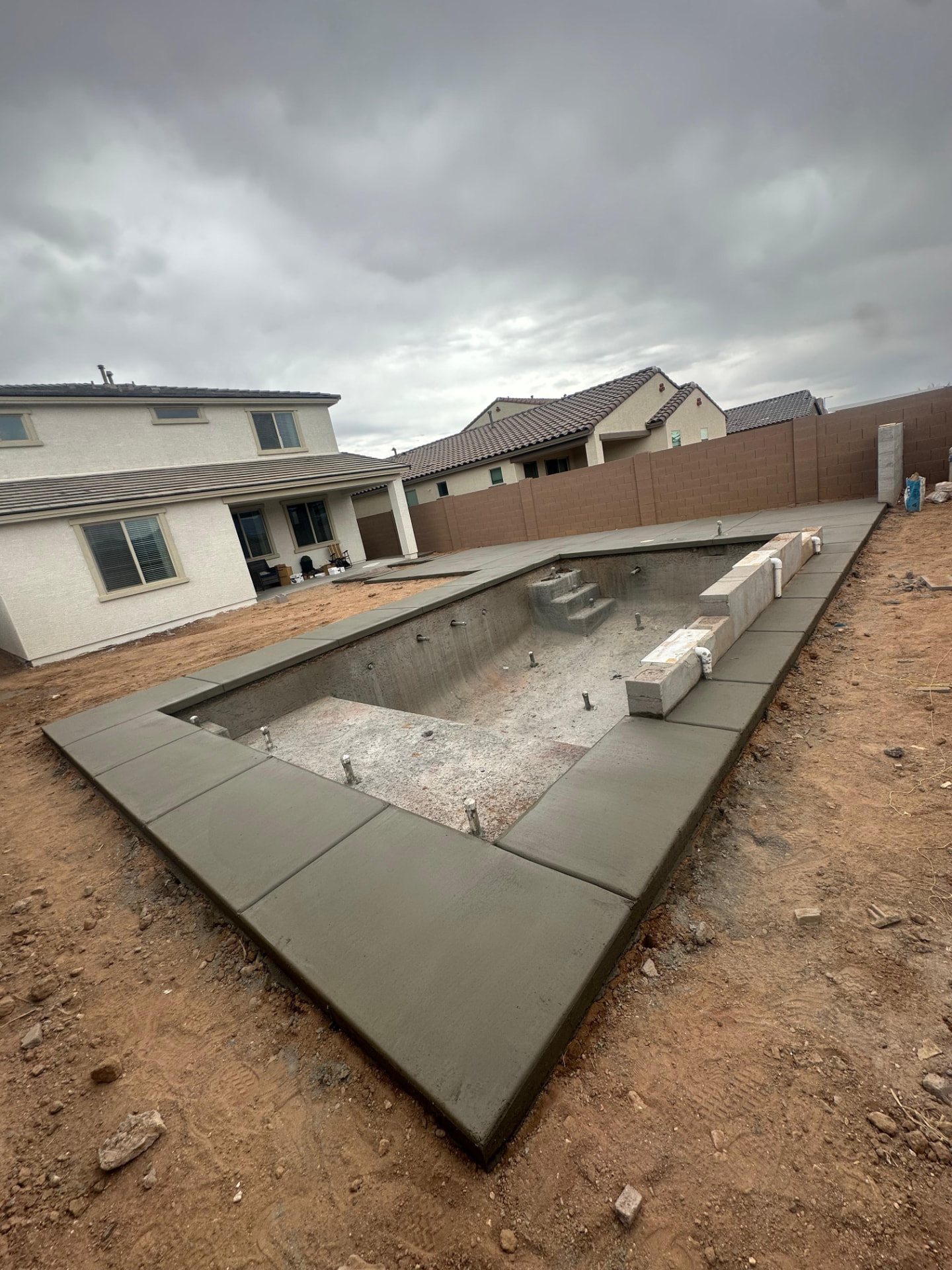 Bare gray concrete pool deck before cool deck coating in Phoenix AZ