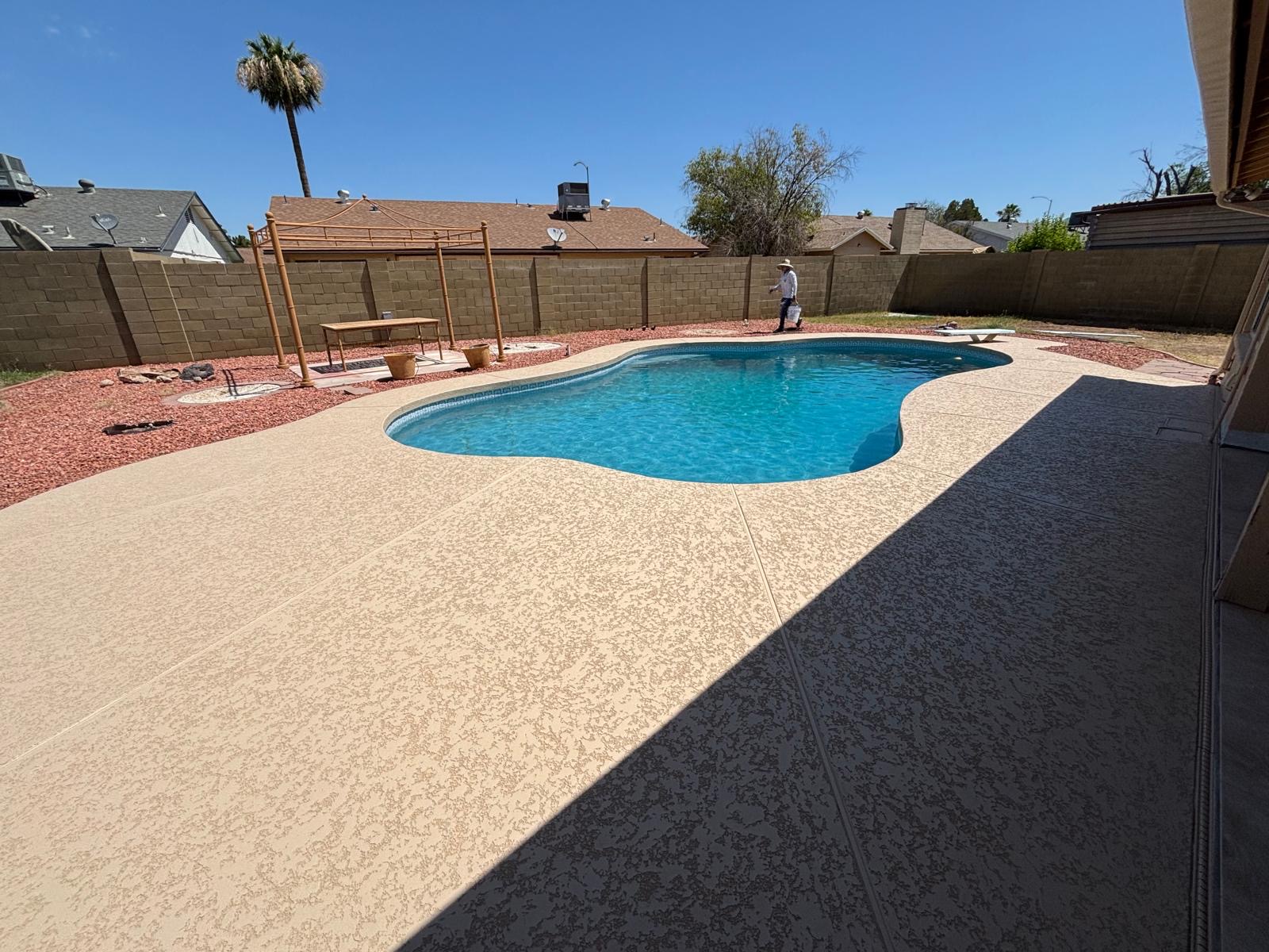 Tan cool deck coating with lace texture around a Phoenix backyard pool
